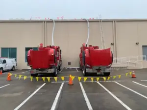 Red Adler trucks vacuuming a roof
